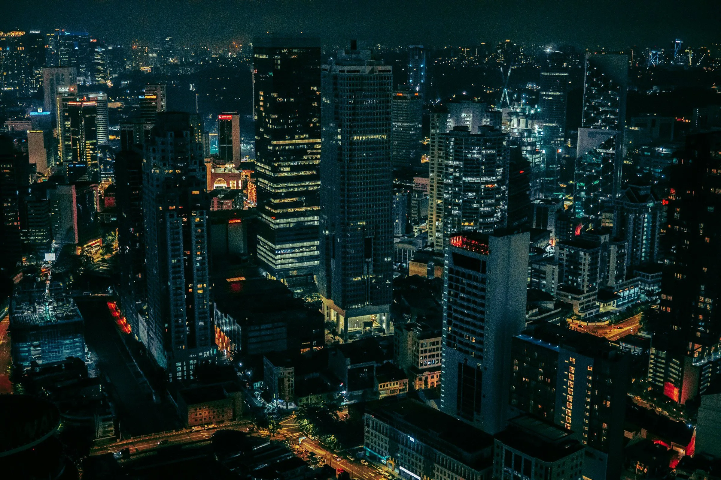 City skyline lit up at night, seen from above